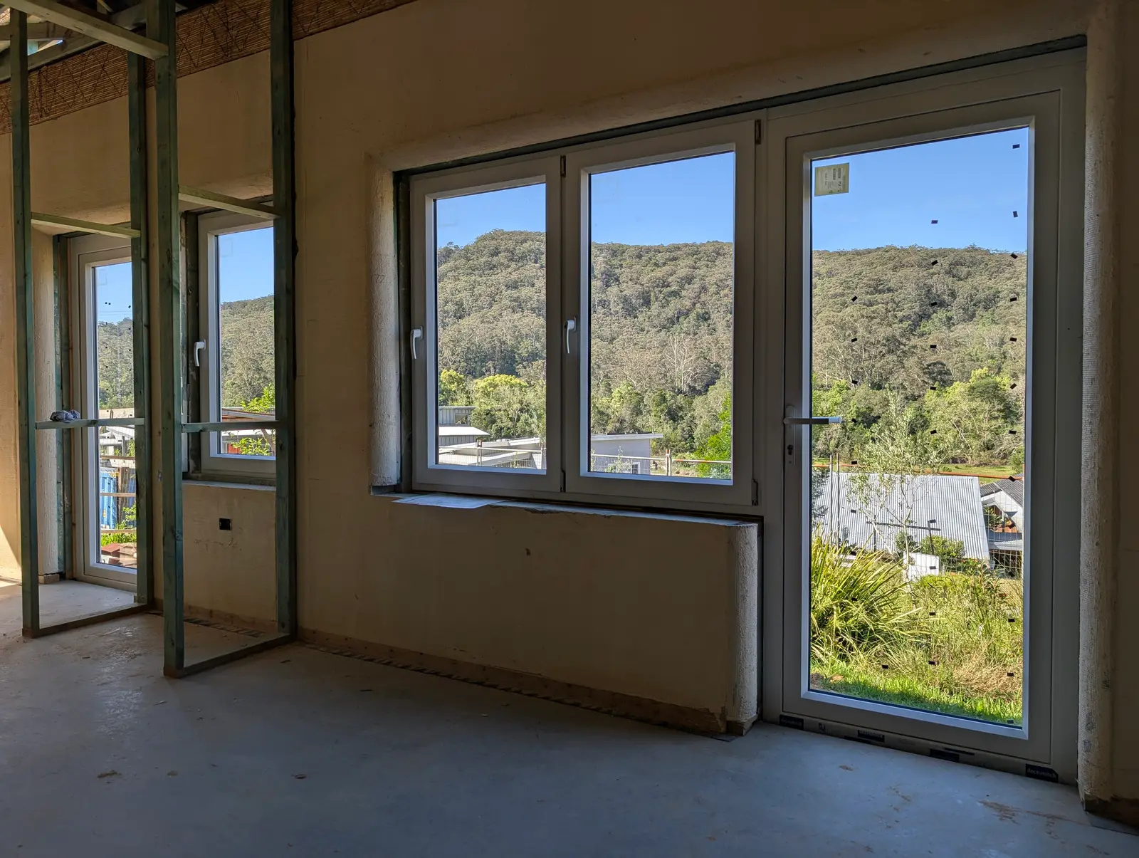 The Courtyard Strawbale House at Narara Ecovillage, its living room windows framing the ridge