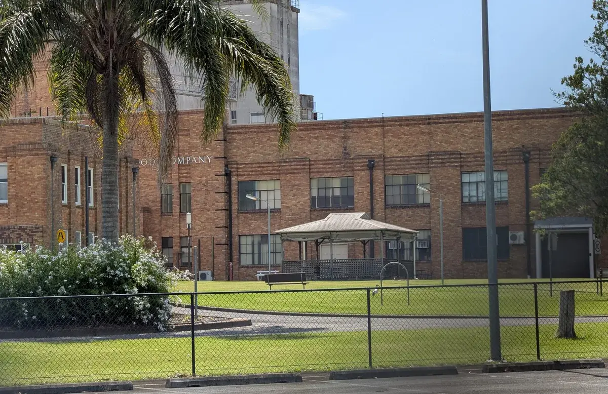 Historic brick Avondale dairy building with a rotunda and palm tree