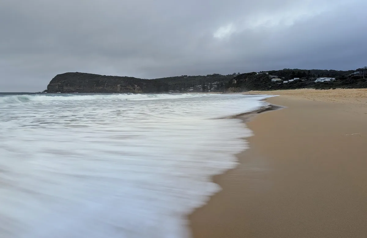 Wide view of the surf and headlands along Copacabana Beach