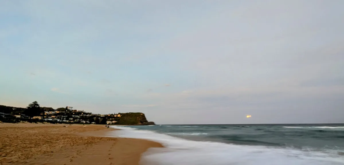 Dusk view along North Avoca beach towards the headland