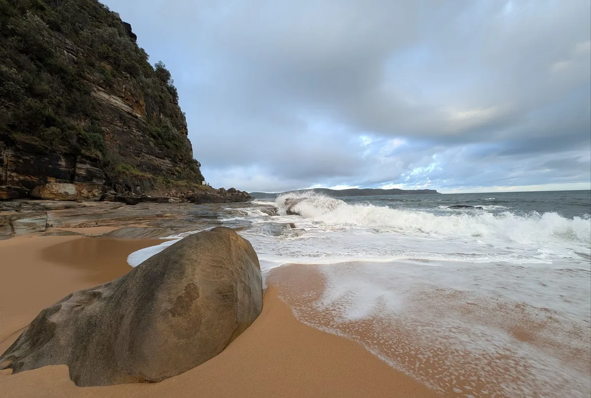 Waves breaking below a sandstone headland at Pearl Beach