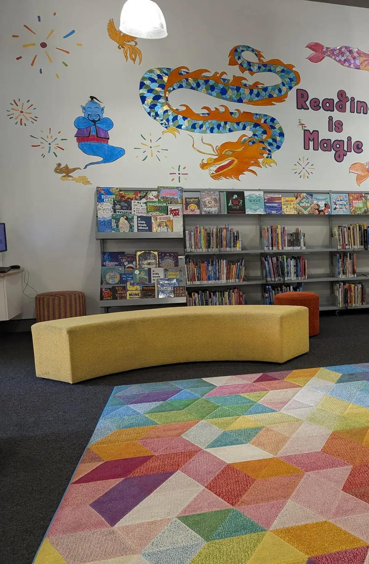 colourful themed reading nook and bookshelves in a children's library